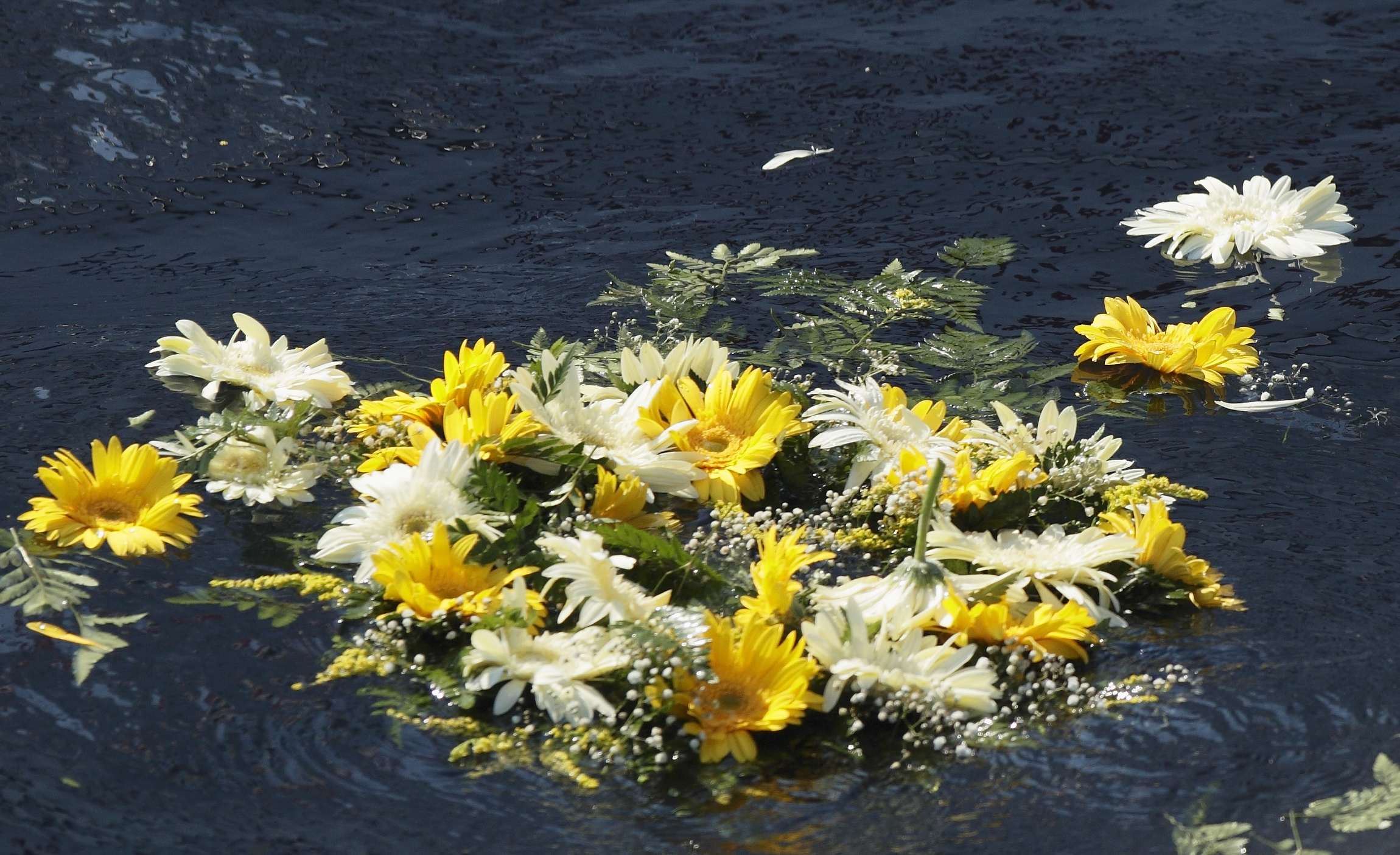 Image: A wreath of flowers thrown by Pope Francis floats in the Mediterranean Sea in the waters off the Italian island of Lampedusa in this July 8, 2013, file photo. 