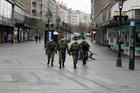 In this March 26, 2020, photo, Serbian army soldiers patrol Belgrade’s main pedestrian street as part of the government’s efforts to contain the coronavirus pandemic. (AP Photo/Darko Vojinovic)